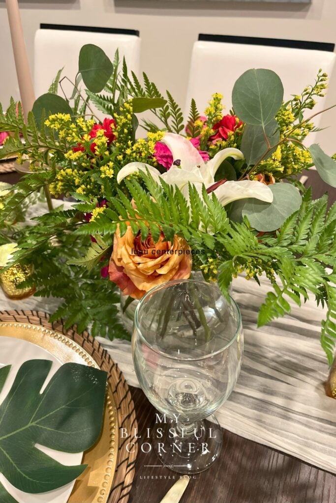 Easy tropical centerpiece idea with fresh flowers greenery and fern leaves for party table