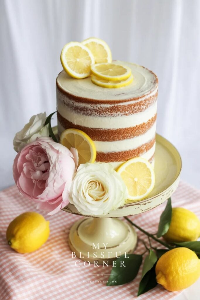 freshly graduated theme cake with pink and white flowers and lemon slices, binham tablecloth