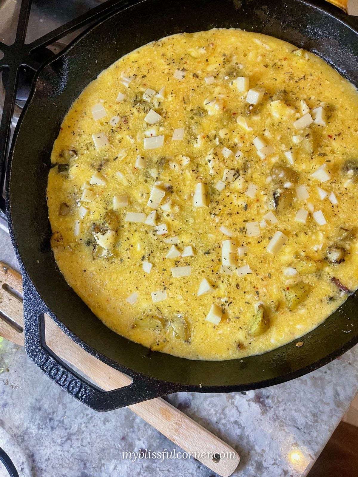 egg bake topped with white cheddar before baking